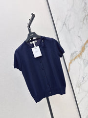 Short-sleeved knit top with a bow-accented round neck