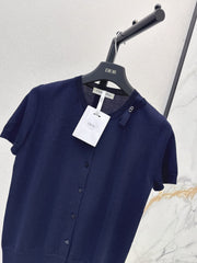 Short-sleeved knit top with a bow-accented round neck