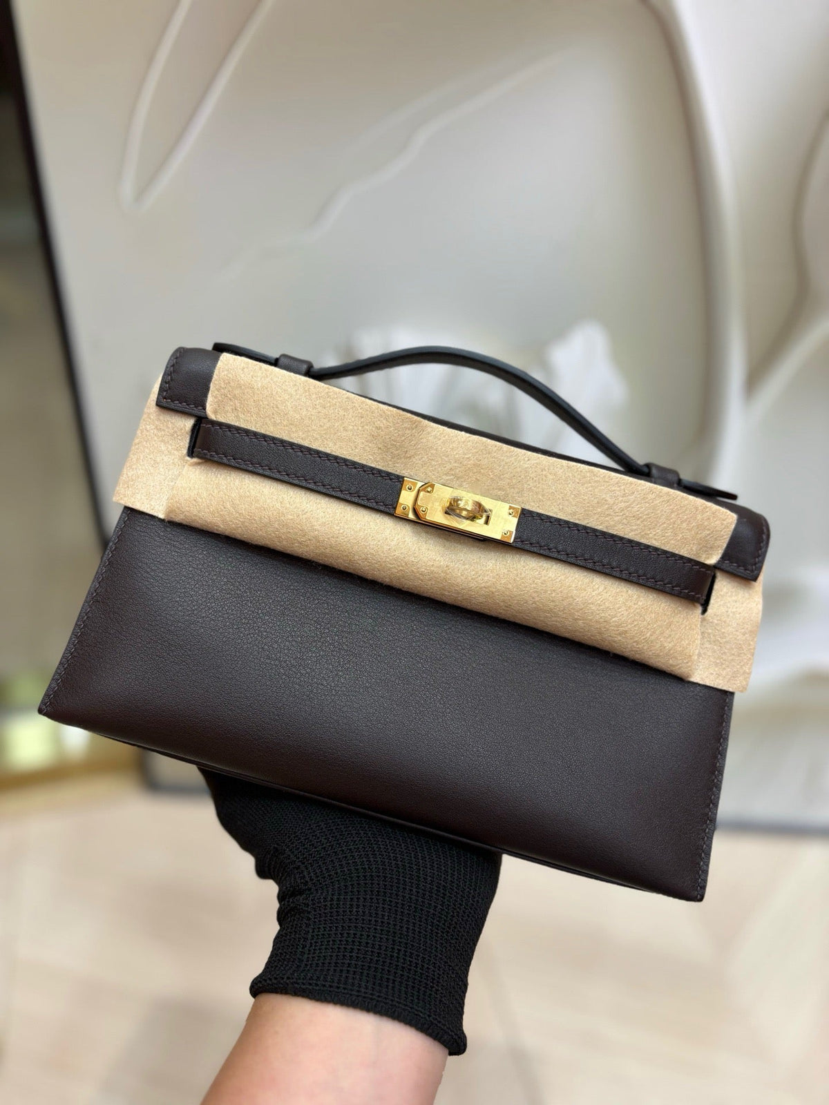 brown pochette with gold hardware